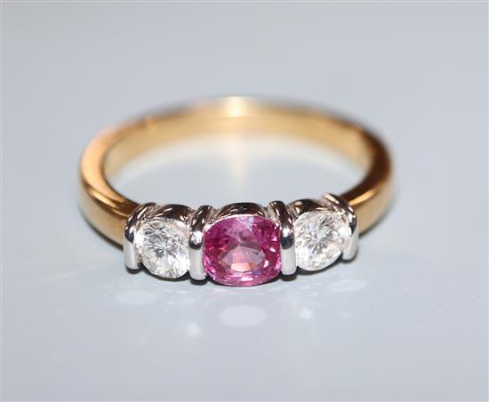 A modern 18ct gold, pink sapphire and diamond three stone ring, size M.